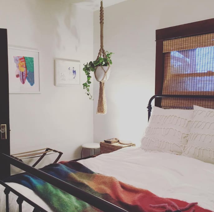 Your cozy bedroom with comfy queen bed, fine art, and bohemian botanicals!