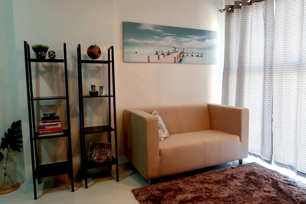 A relaxed vibe in the living room. Open the curtains to let the light in.