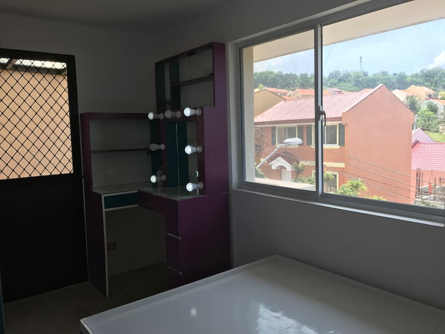 The Master's Bedroom with adjoining balcony. It's on the 3rd level with great view. Adjoining balcony is airy and overlooking the city and Azienda's very peaceful community.