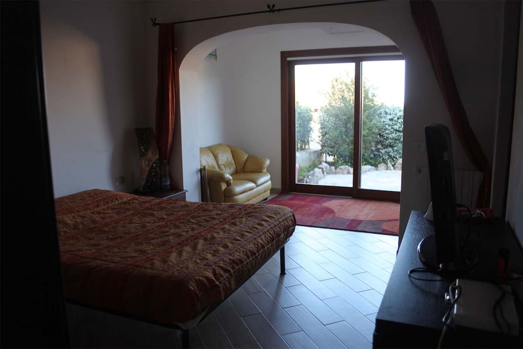 Master bedroom on ground floor with en suite bathroom and direct access to small garden in rear of the house