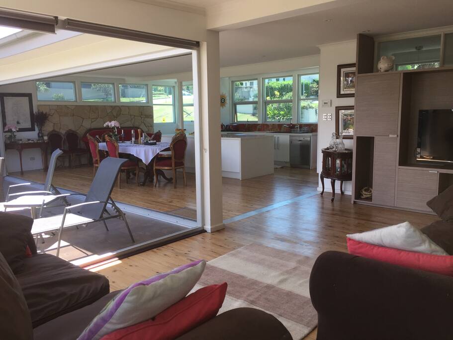 Open plan kitchen dining lounge with consertina glass doors opening onto alfresco dining area
