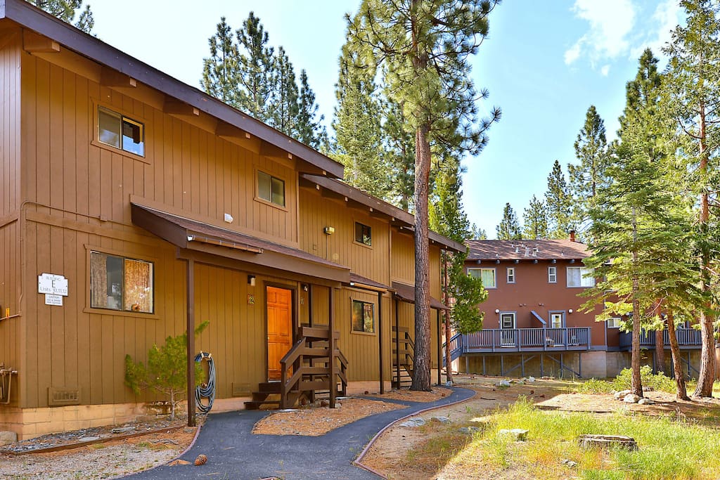 This charming home is surrounded by magnificent pines.