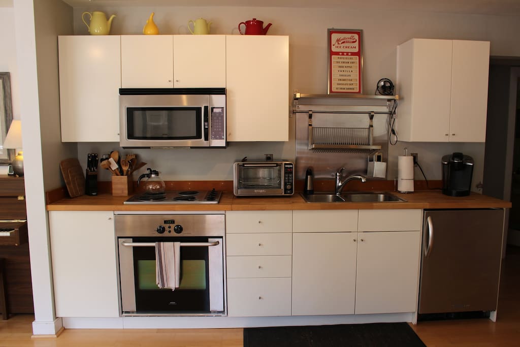 Kitchen amenities include a full-sized oven/stove, Keurig, toaster oven, microwave & full-sized fridge (not pictured)