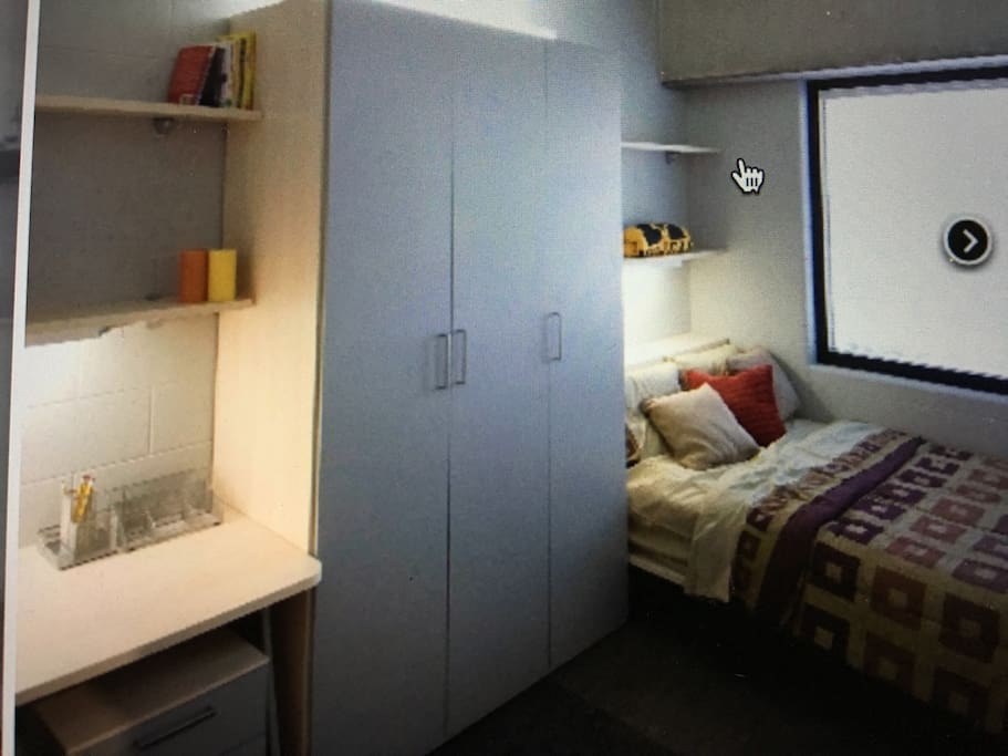 Private bedroom with cabinet and desk