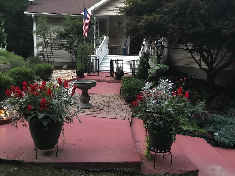 Main entry to the house offers well maintained and inviting garden setting.