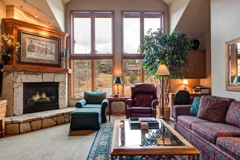 Lots of natural light, comfortable furniture and cozy fireplace highlight the living room