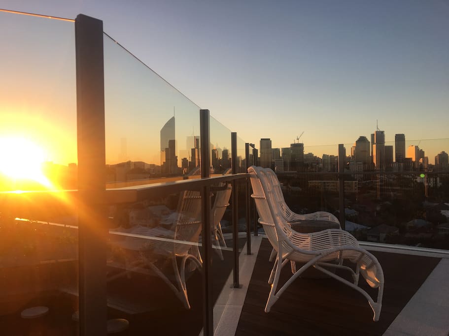 Roof top pool sunset looking over the city