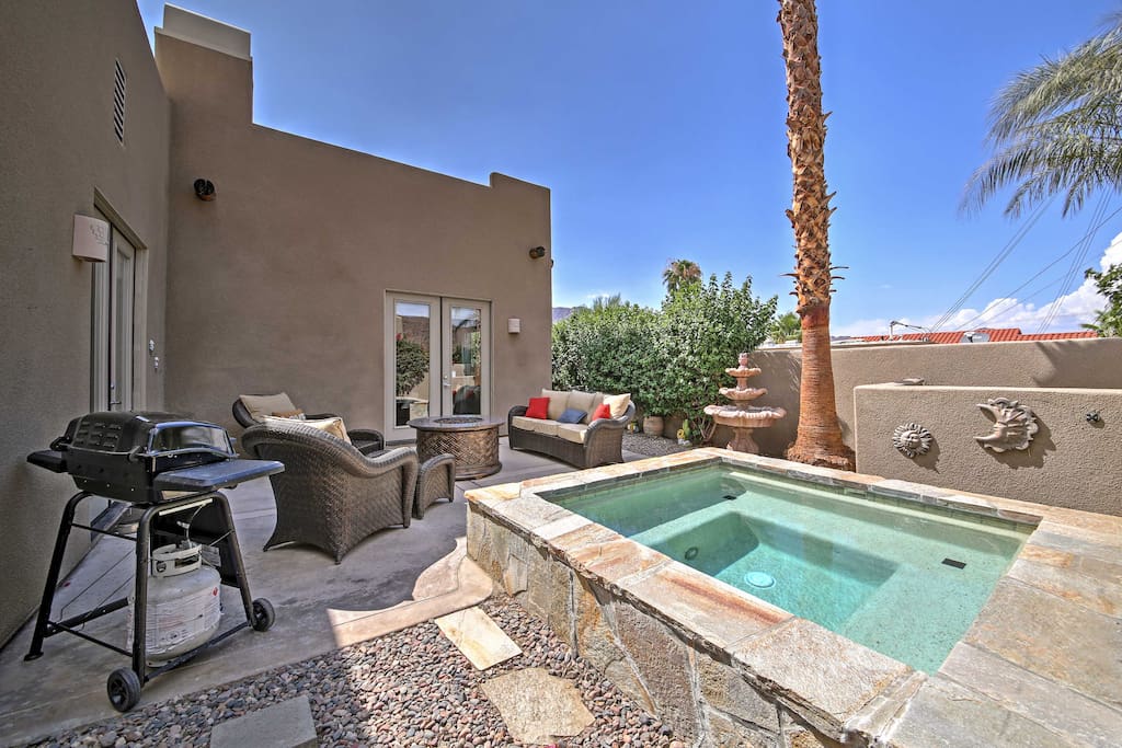 The back patio features a spa, fire pit and barbecue grill.