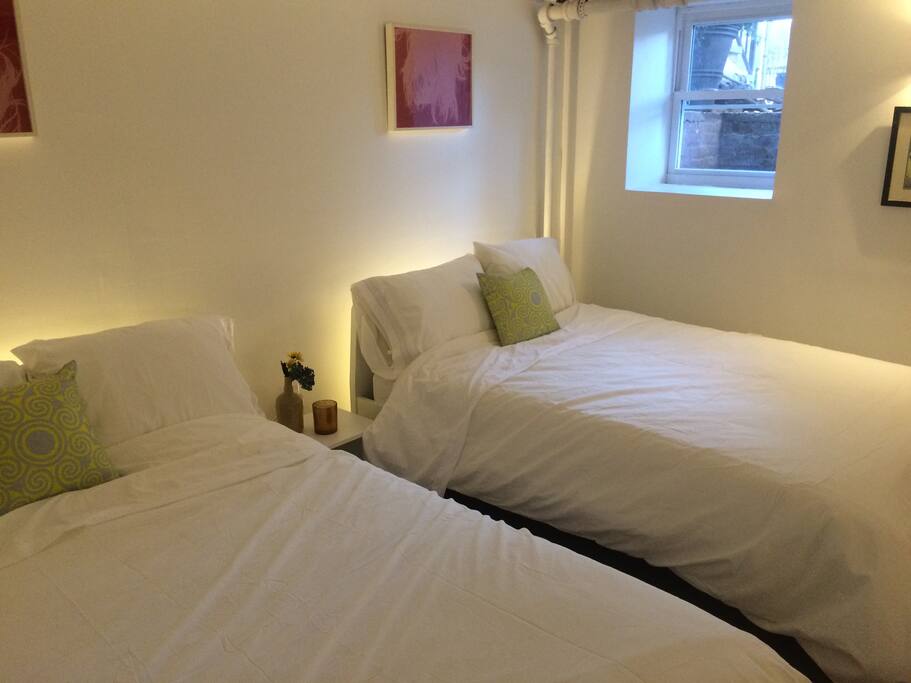 The bedroom suite has two double sized beds and a view to outside