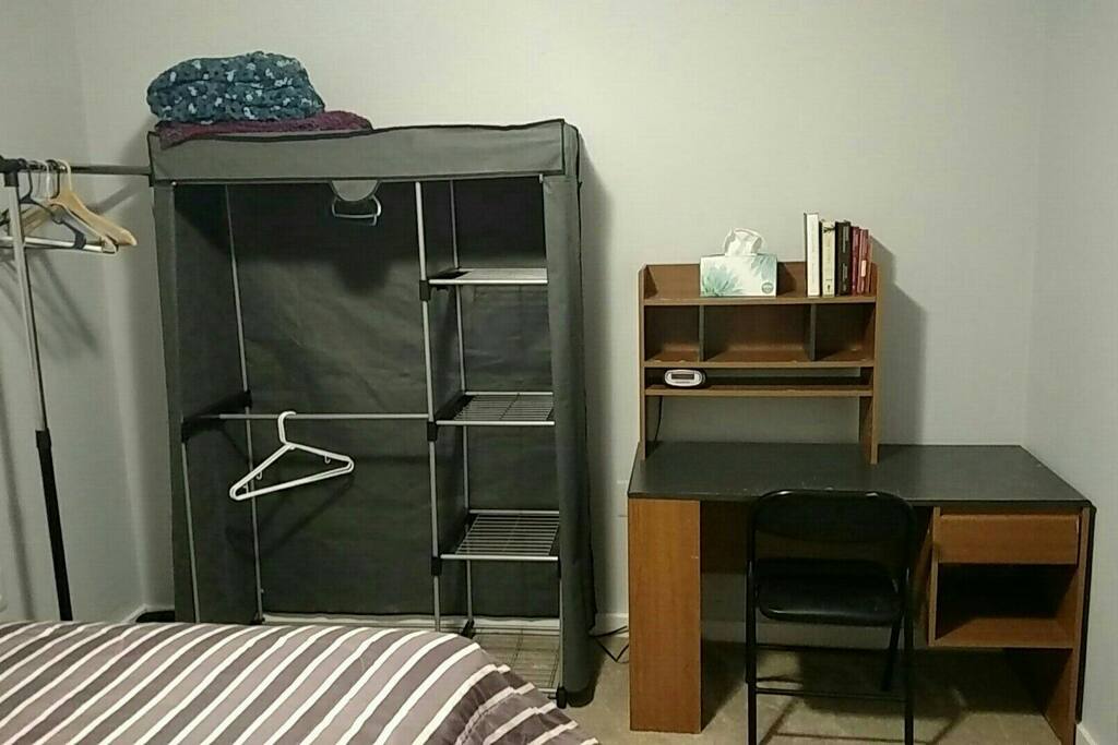 Plenty of hanging space for your clothing & a desk to work at