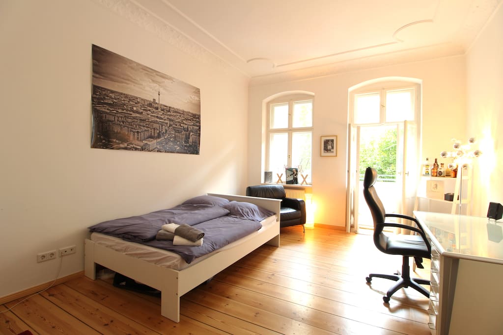The old building apartment has high walls, stucco and large windows.