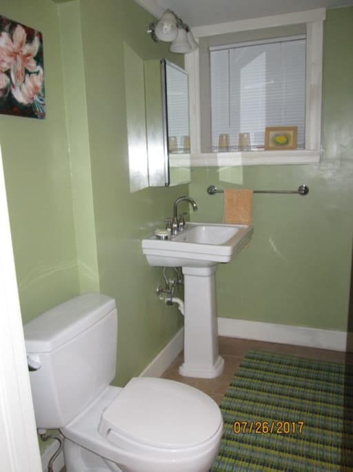Private Bathroom with shower across hallway from bedroom.