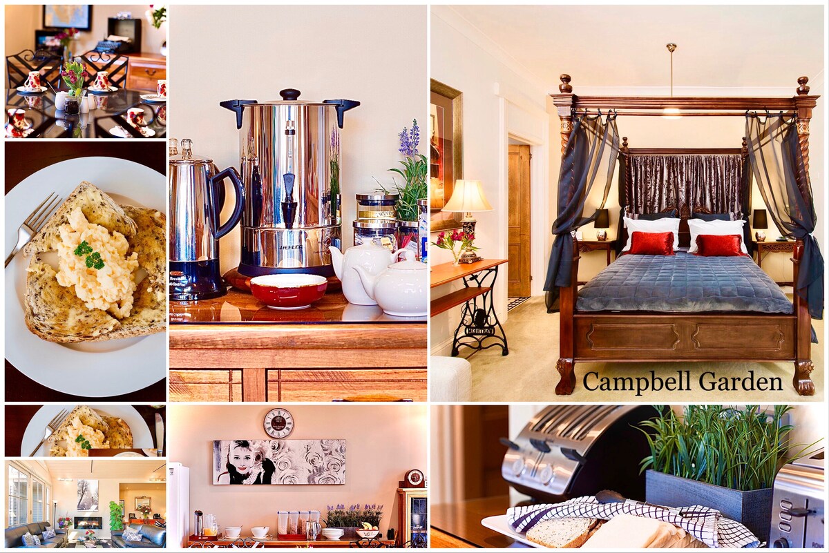 The image showcases a cozy dining area featuring a plate of scrambled eggs with herbs, alongside a gleaming coffee pot and fresh flowers. A spacious four-poster queen bed is presented with decorative pillows. A well-arranged table and a glimpse of the living area contribute to a warm ambience.
