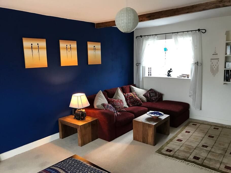 Lounge space in room with cozy corner sofa.