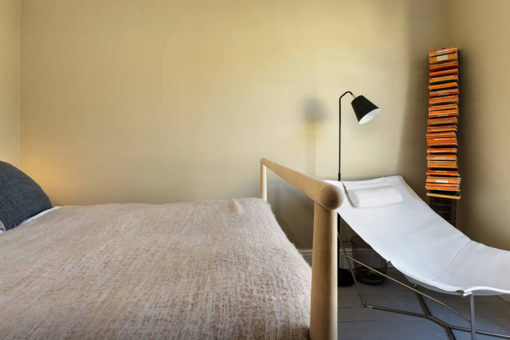 The bedroom has a scandinavian style influence mixed with modern and vintage pieces