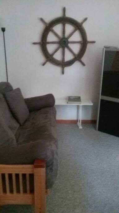 Futon facing large screen television in living area