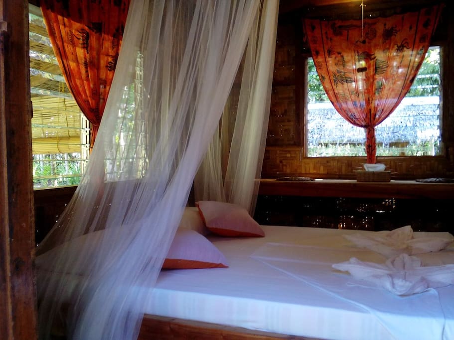 Bedroom of Orange bungalow with queen size bed