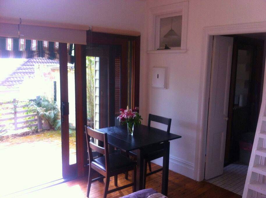 Internal dining table and chairs looking out onto private balcony