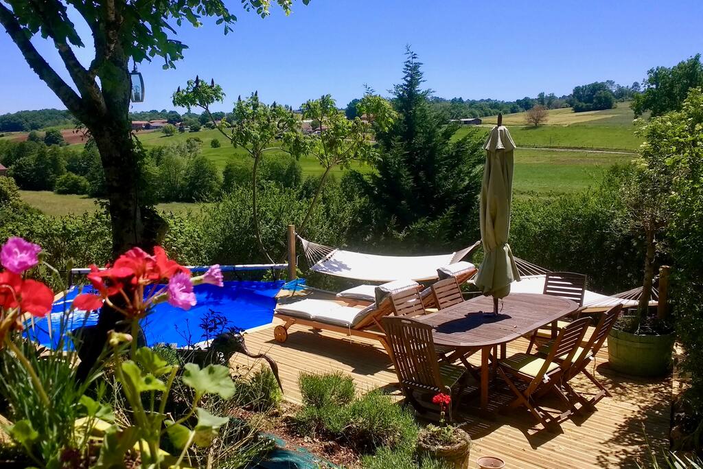 The large extended decking area features a dip pool, hammocks, sun loungers and a dining table