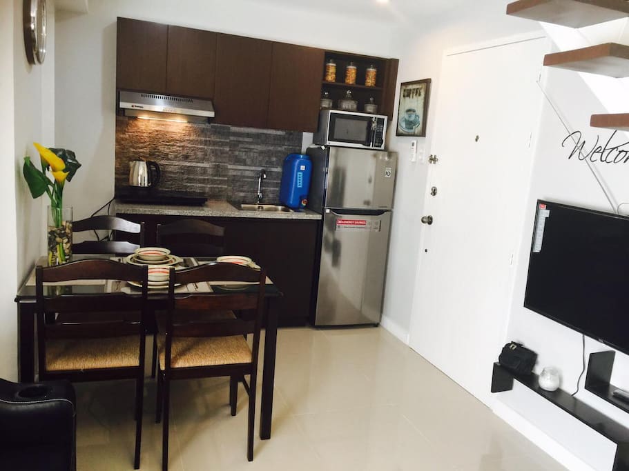 Kitchen/Dining Area showing large screen TV