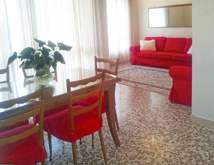 THE DINING ROOM WITH THE BALCONY AND THE LIVING ROOM