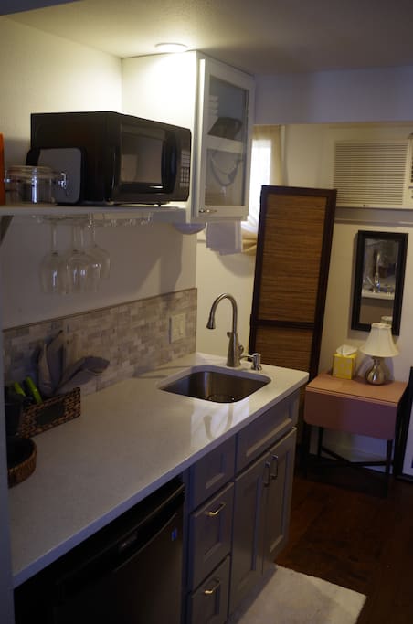 Efficiency kitchen with microwave, sink, under counter refrigerator, separate ice maker. Coffee press, and the makings. Fresh muffins for a snack.