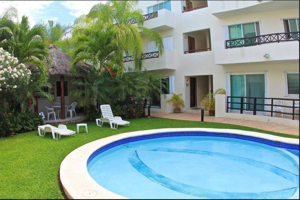 Large Pool with a Palapa and Lounge Chairs