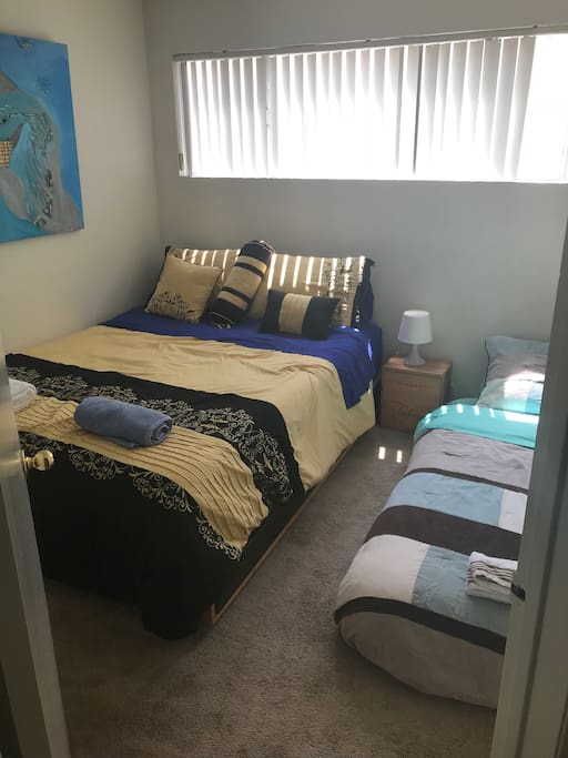 This is how it looks when we have three guests: we rotate the queen, so there's room for a twin size air mattress ...
Please understand, the air mattress only comes out when we have 3 guests, not 2.
It’s a small room and yes, it’s a tight fit, but it’s all possible.