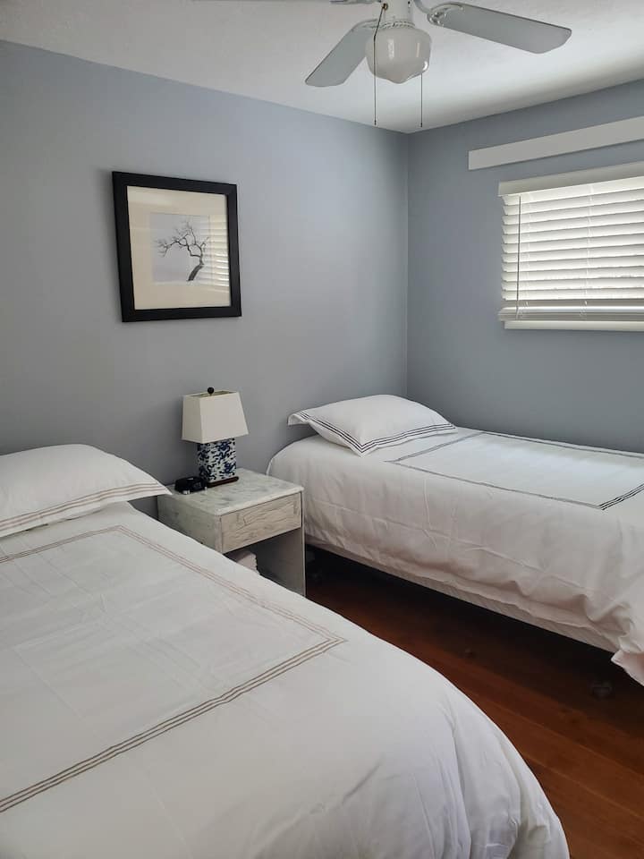 Back bedroom with 1 full & 1 twin affectionately dubbed, "the kids room" as it is the only bedroom with a TV.  North & South facing window allow welcoming light any time of day
