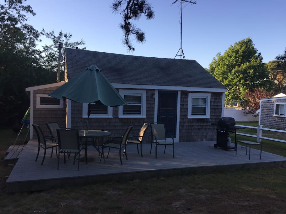 Front of house with big deck and gas grille