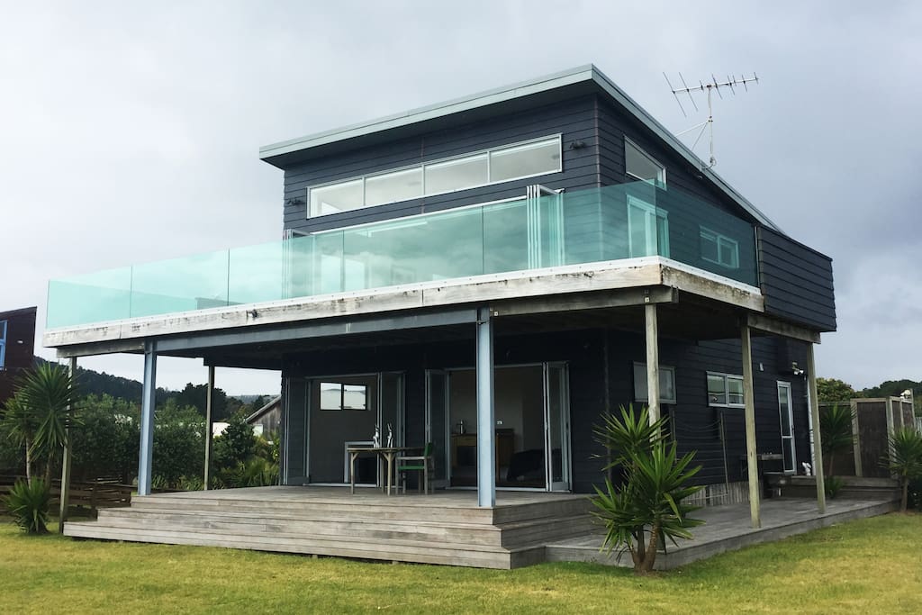 Facing the beach with full ocean views, full deck upstairs and down with hot outdoor nature shower and BBQs.