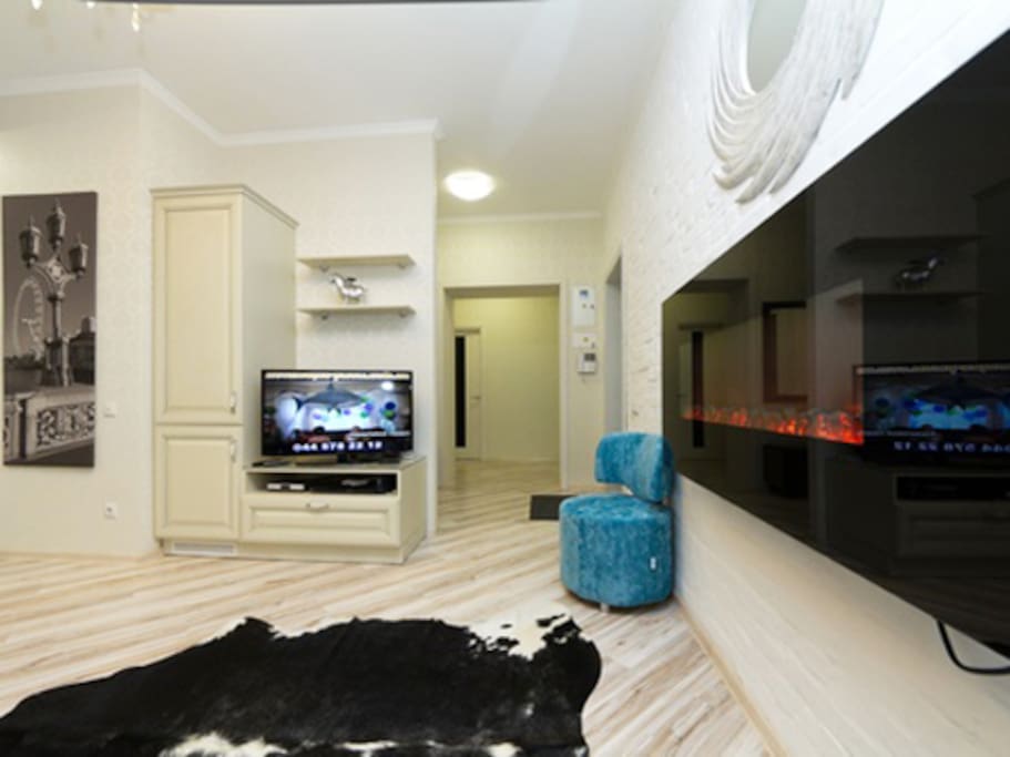 Living-room with fire-place, open studio-kitchen