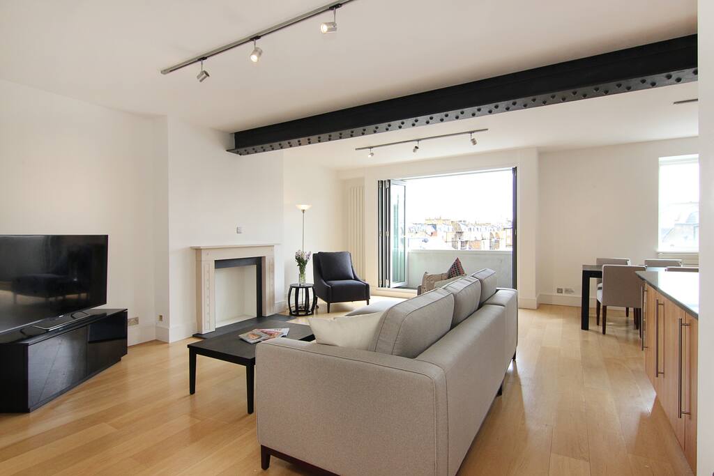 The luxurious Lounge area with feature fireplace and exposed beams.