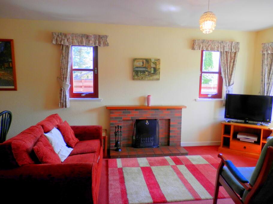Lounge/dining-room with open fire and sofa bed