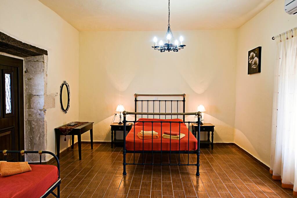 Bedroom with a double bed and two single beds! We can add an extra bed if you wish, free of charge!