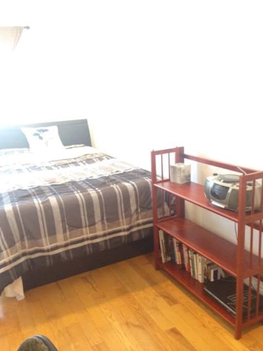 The room will include a bookshelf with a variety of books/magazines for entertainment.
