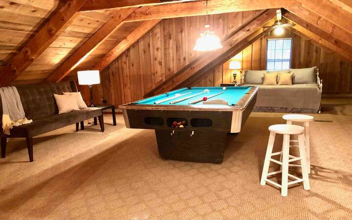 Loft overlooks the living room and has a trundle bed, pool table, and extra seating
