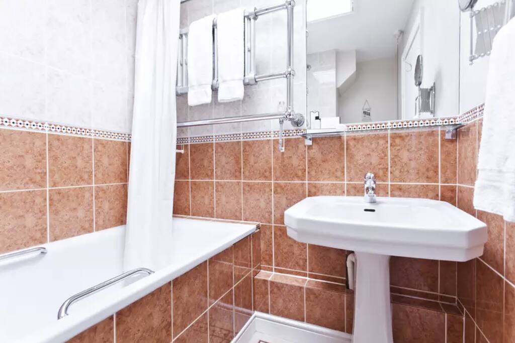 Bathroom with bath and shower