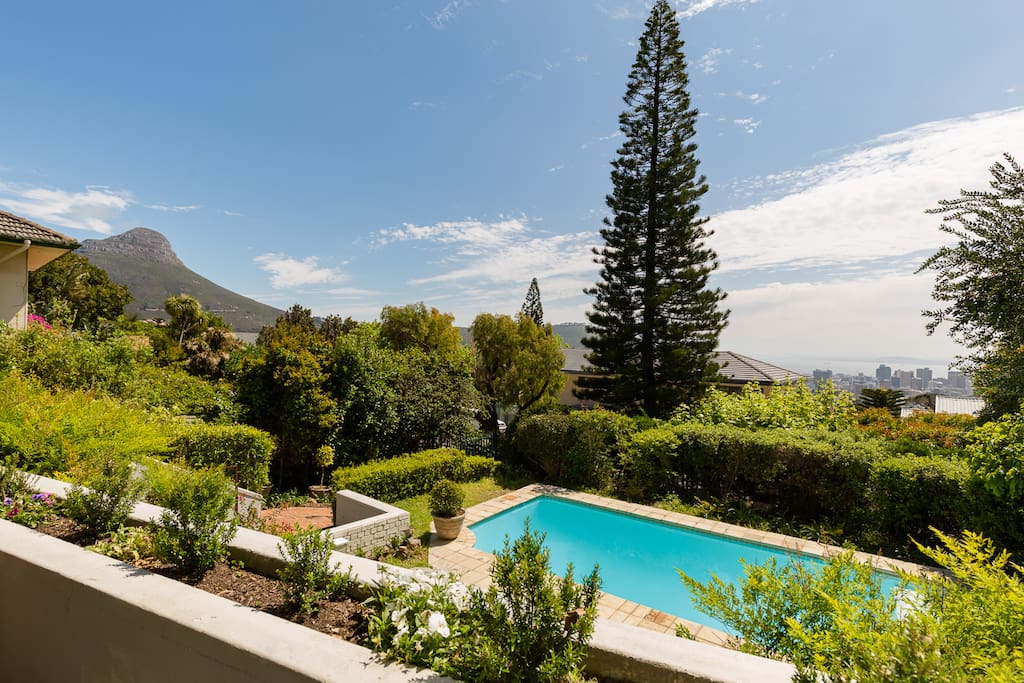 Patio and pool with swooping views of Lions head, the city and Cape Town harbour in the distance