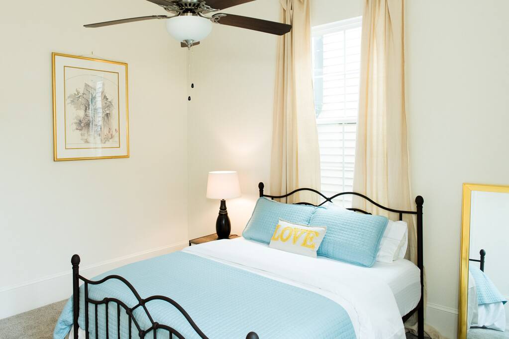 Master bedroom with tempurpedic queen-sized bed and backyard access