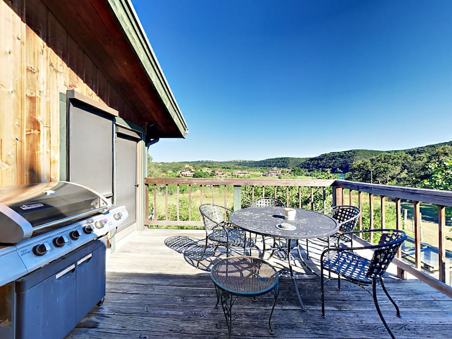 The patio is outfitted with a gas grill and round metal table with 4 chairs