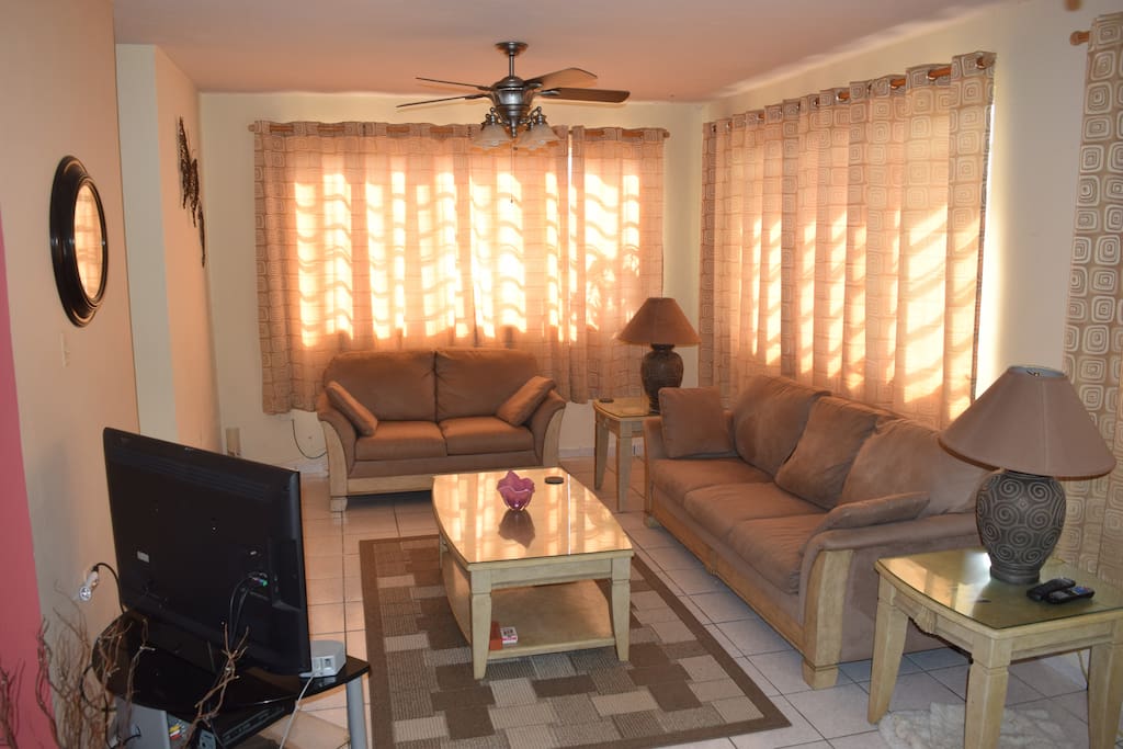 Large living room, with comfortable seating for 4 and TV with cable.
