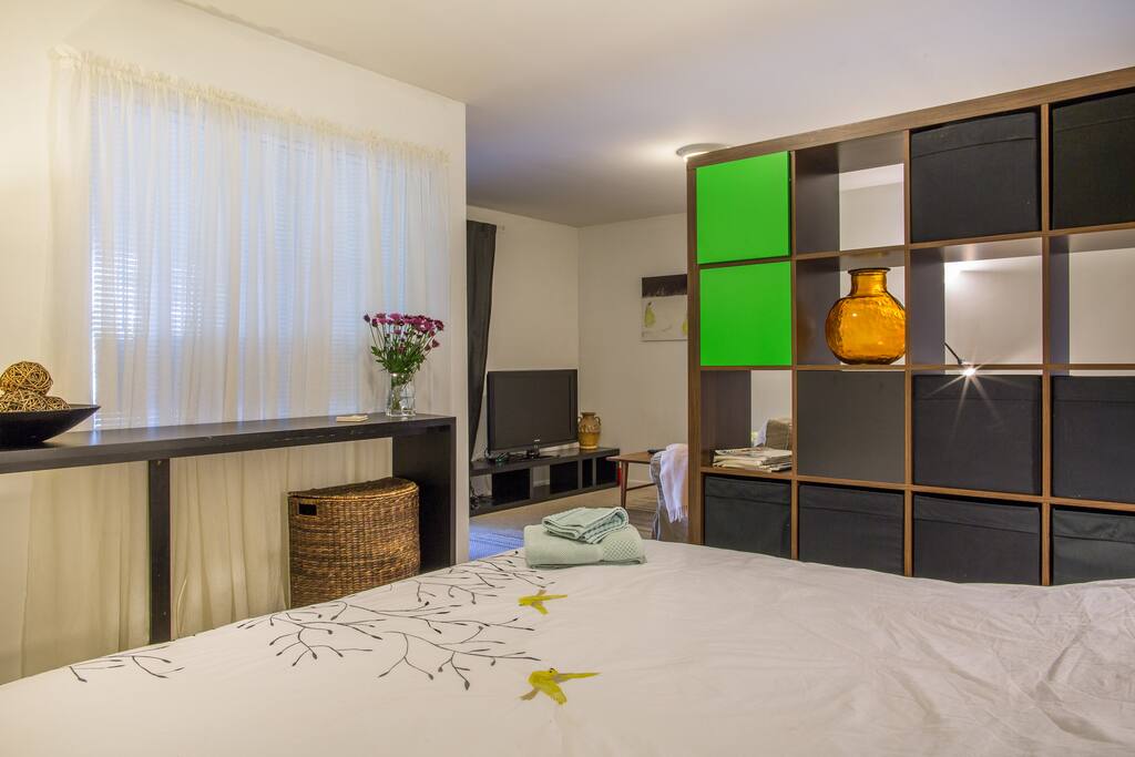 A large window and glass sliding doors allow plenty of natural light in room.