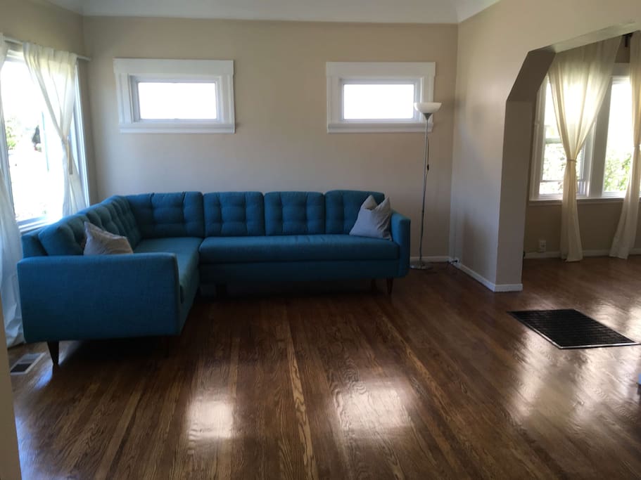 In the living room, this peacock blue couch converts to a queen size bed with the addition of an attachable ottoman (not pictured). Very comfortable for additional guests.