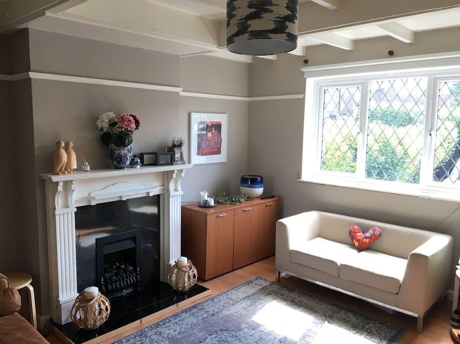 Lovely bright and sunny living area with a fireplace, TV and comfortable coaches to relax on.