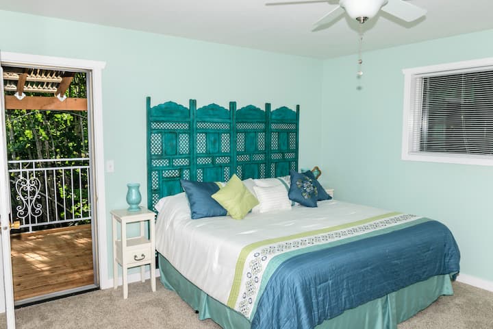 Master bedroom retreat featuring a king-sized tempurpedic bed, electric fireplace, private balcony, and masterbathroom.