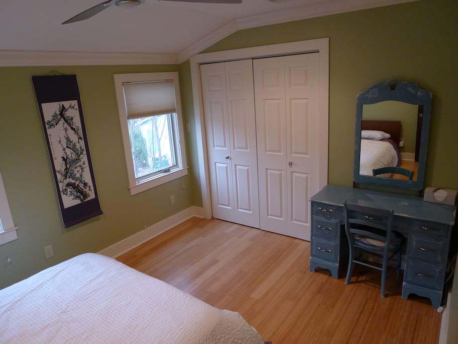 Private and cozy guest room. Vanity drawers all empty, and hanging space in closet for clothes.