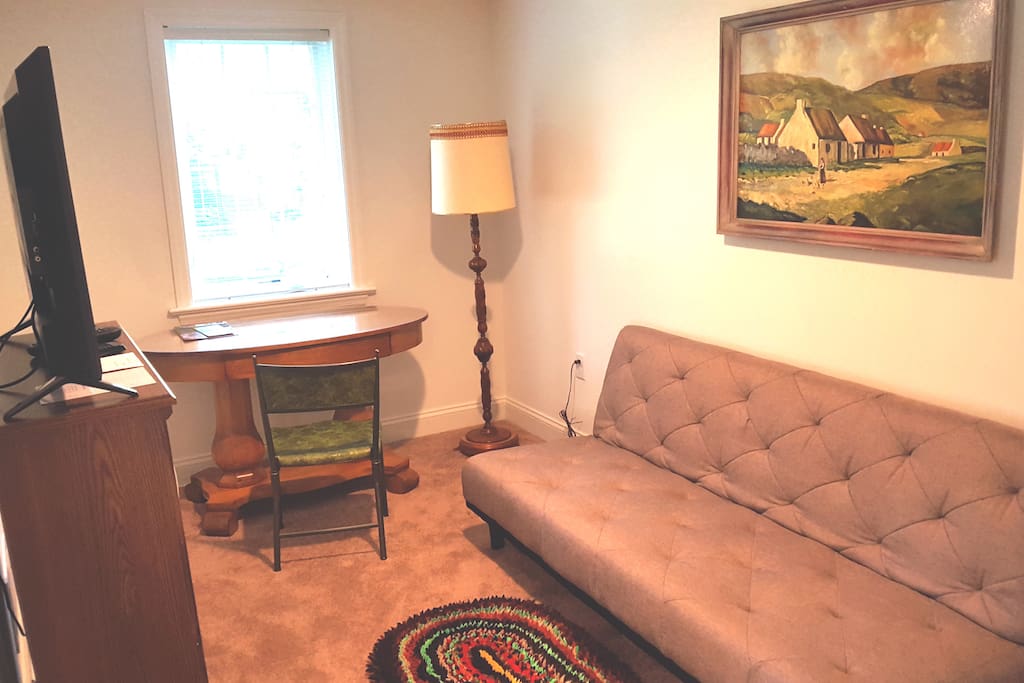 Futon in sitting area of master bedroom w/cable TV and desk