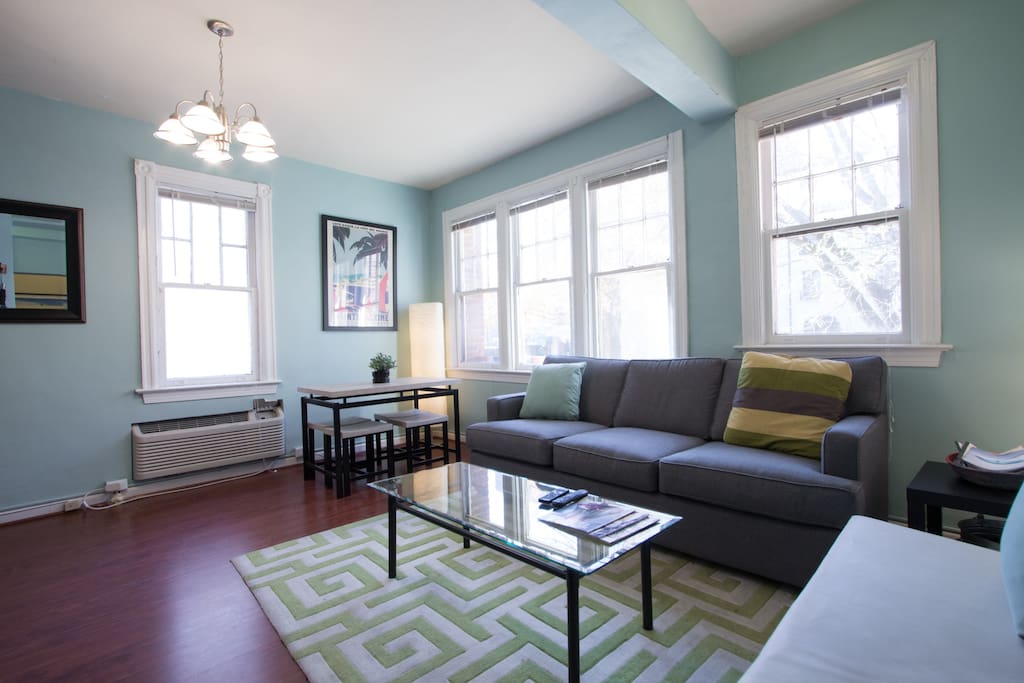 The living room has space to hang out and a kitchen table for four.