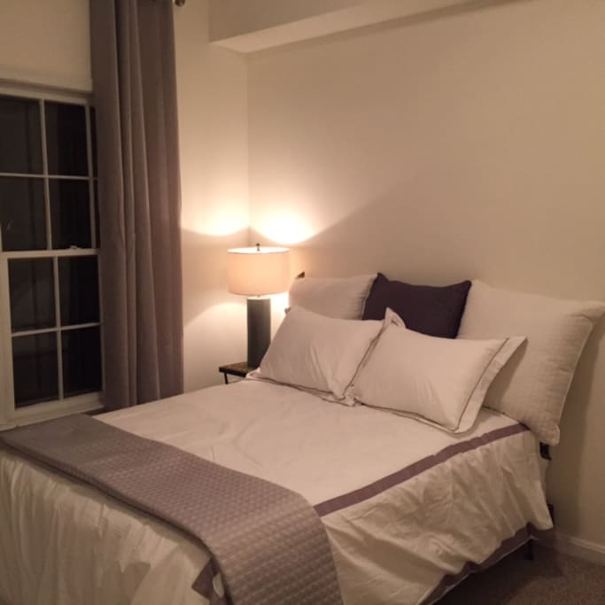 first-floor bedroom with full bed, dresser, and closet